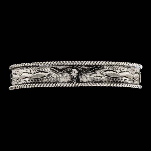 "Elevate your western style with our Keith Western Cuff Bracelet. Crafted on a hand-engraved German Silver base and featuring our signature antique finish, this cuff showcases a traditional rope-edge design. At its center is a figure, complemented by